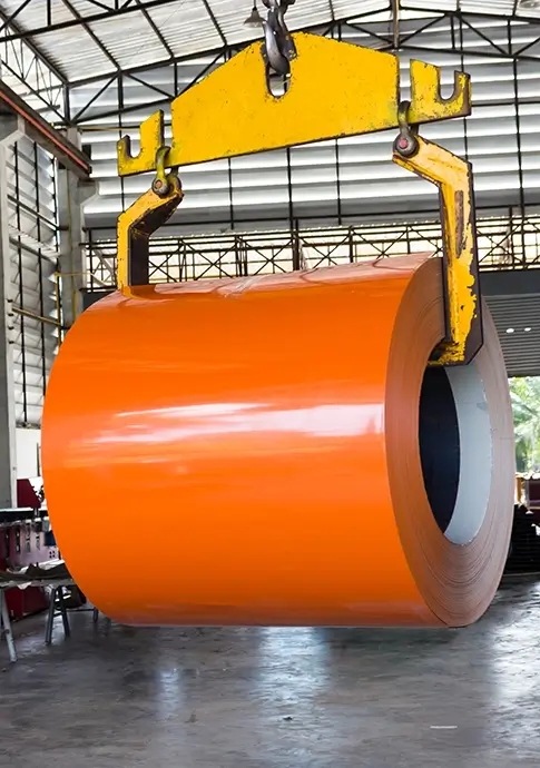 worker inspecting a roll form metal part on a factory floor