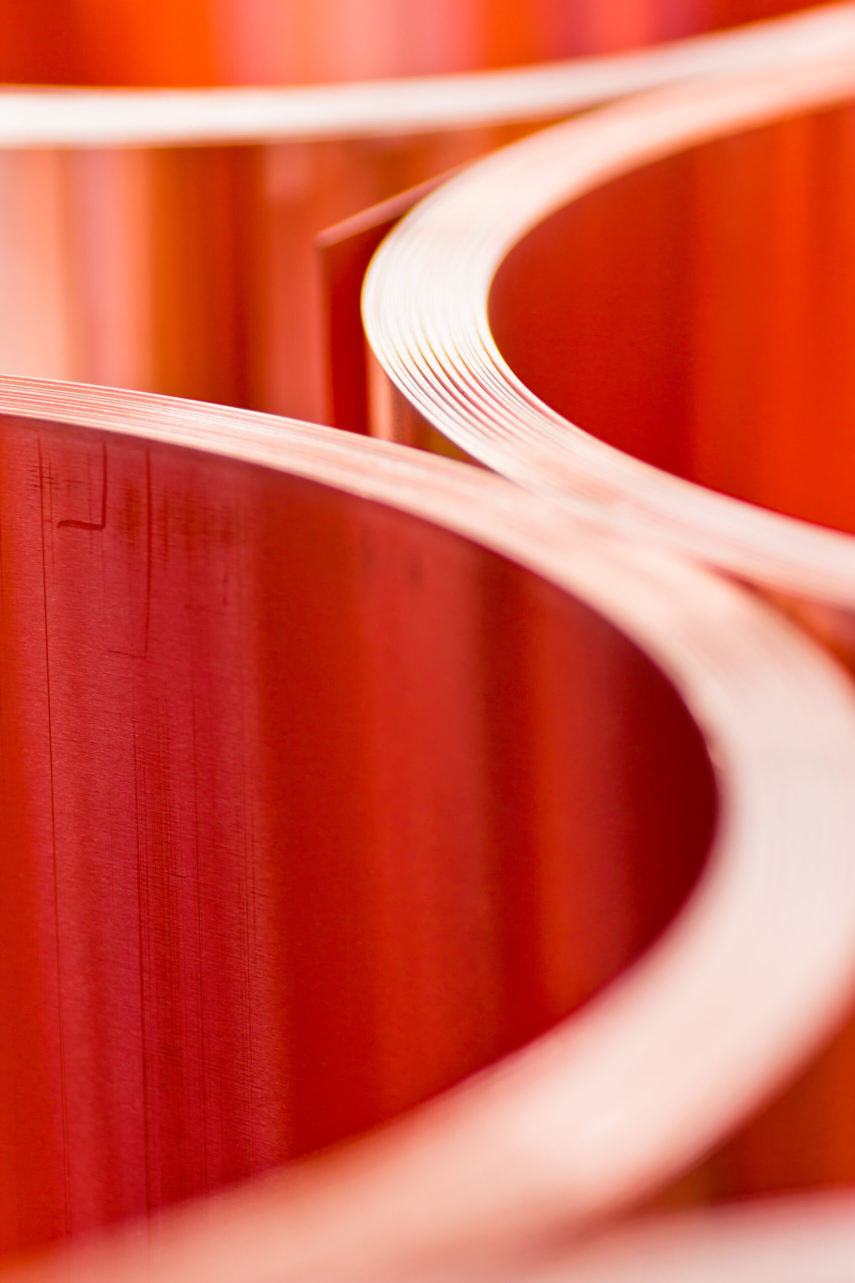 A section of sheet metal is pulled through a roll forming machine on a factory floor