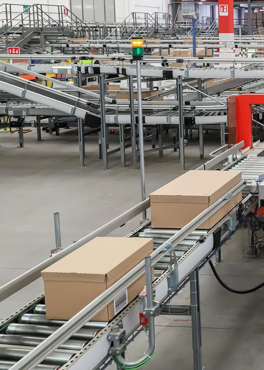 worker inspecting a roll form metal part on a factory floor